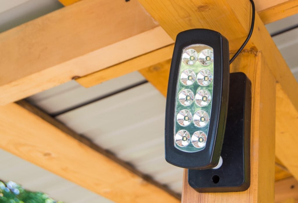 An LED Floodlight on a wooden cabin